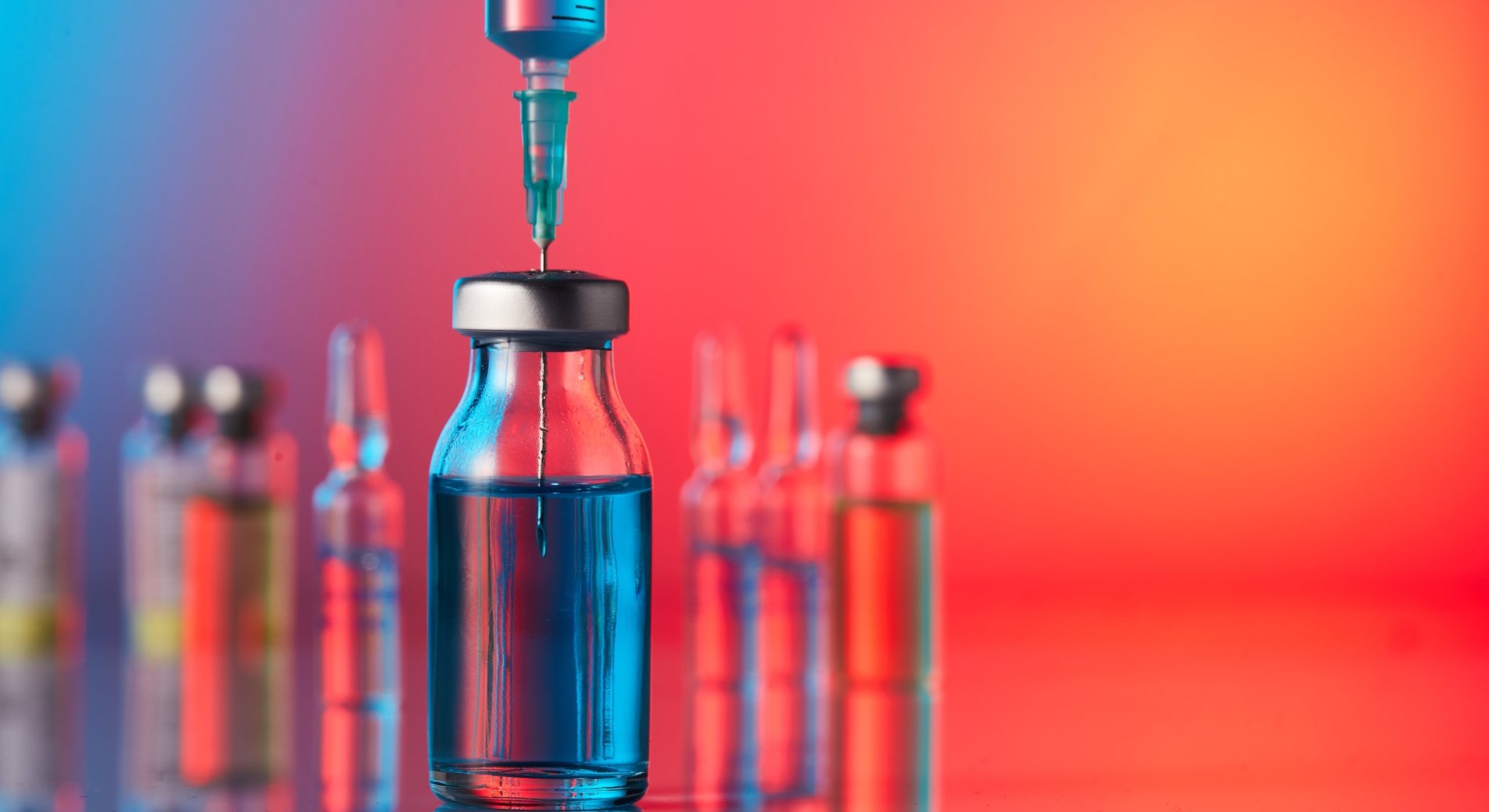 A syringe inserted into a vial.