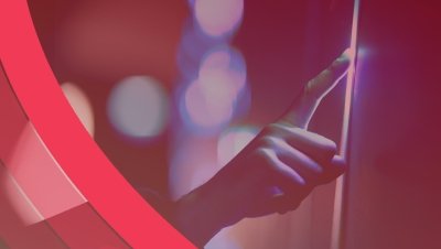 A hand tapping a screen with a crimson overlay.