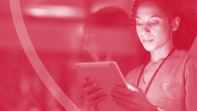 A red tint covering a person looking at a screen.