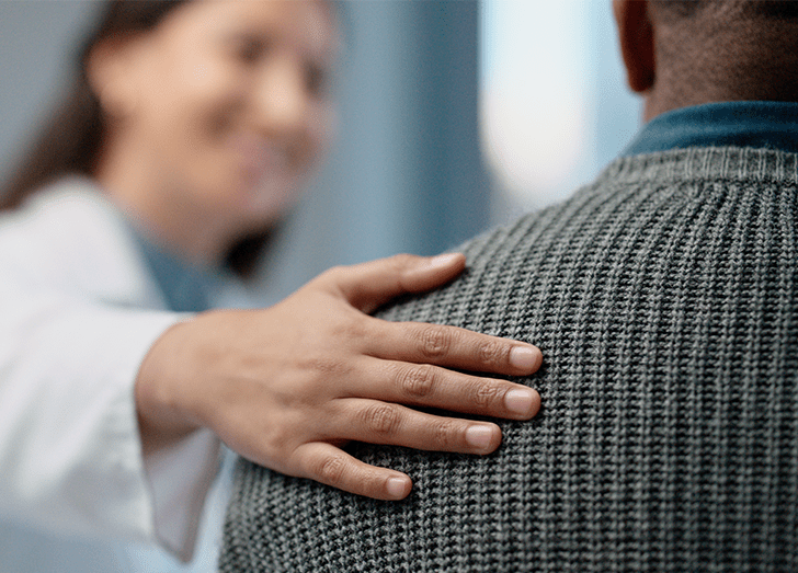 Medical professional in office with patient, discussion and helping hand for wellness.