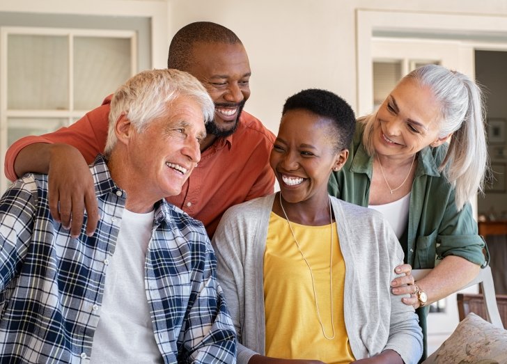 Four people smiling.