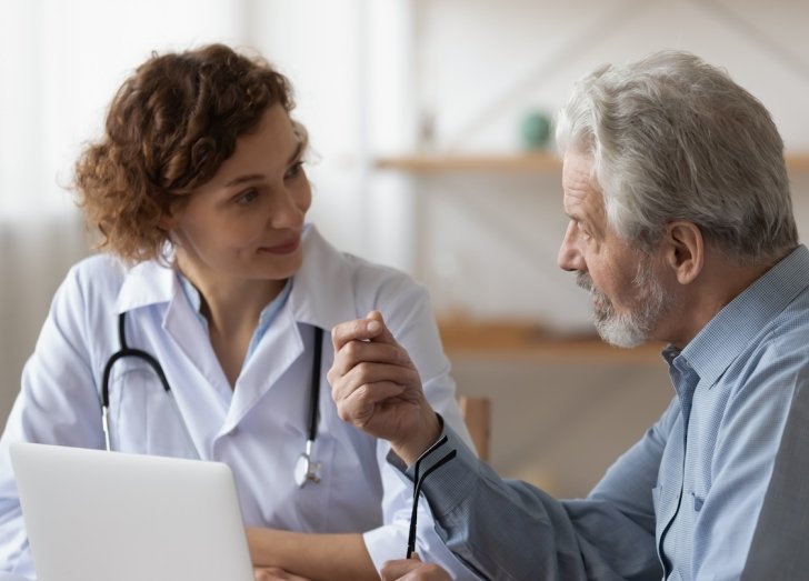 A doctor speaking to a patient.