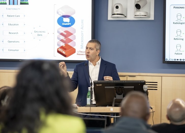 A presenter discussing AI during a workshop.