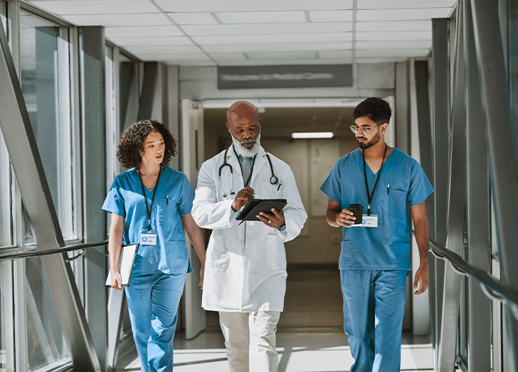 Doctor walking with other doctors.