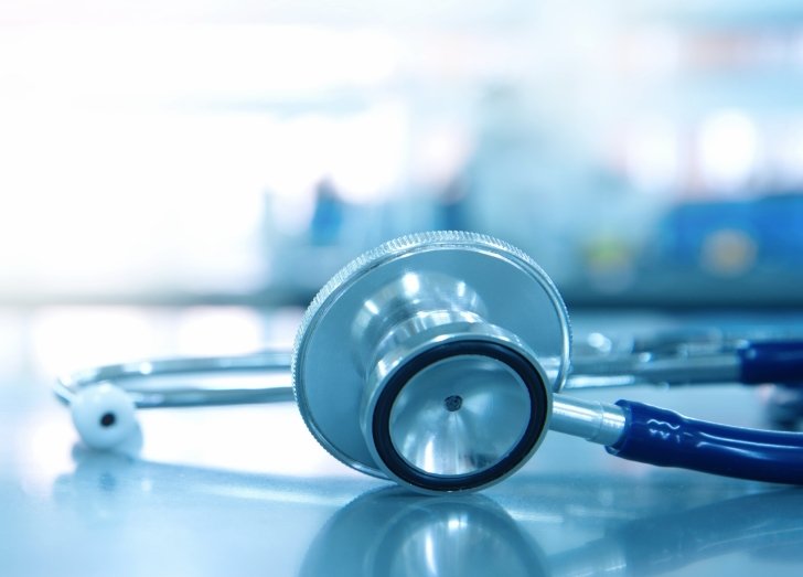 Blue stethoscope on table with blurred background