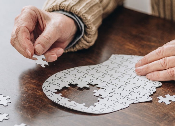 image of an elderly person doing a puzzel.