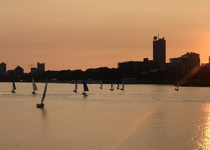 image of a sunset with boats in the distance.