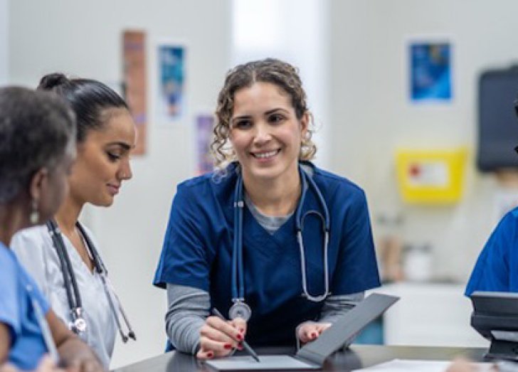 image of physicians collaborating at a table.