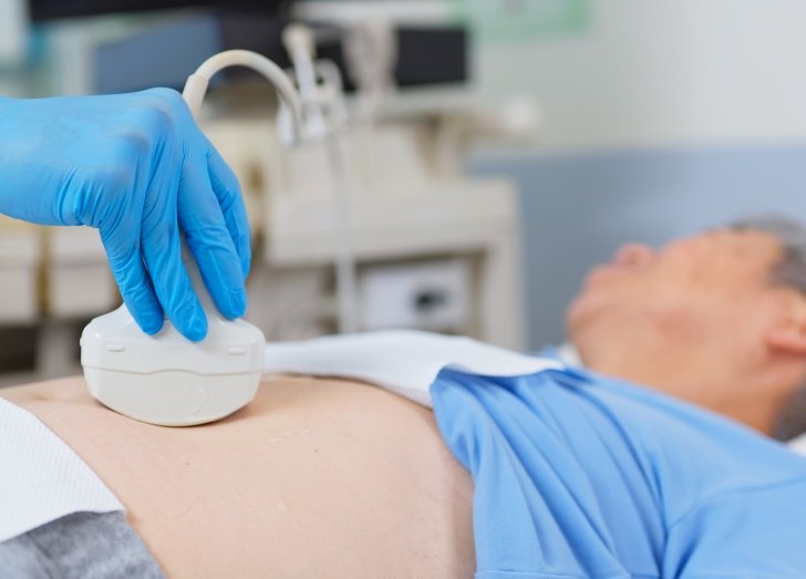 doctor preforming ultrasound on male patient.