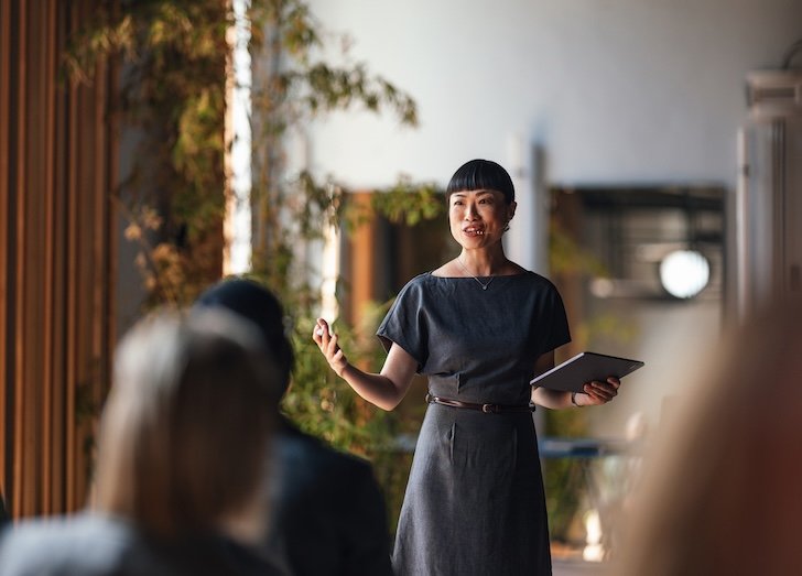 A woman speaking to a room.