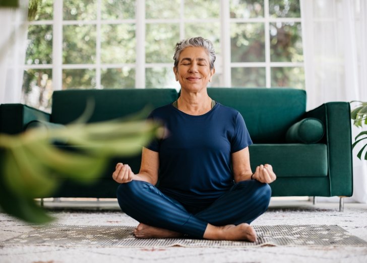 women sitting and meditating on the floor