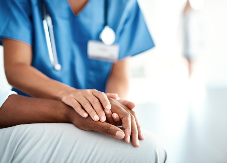 physician holding patients hand.