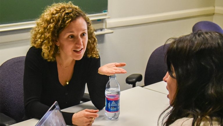 Two woman engaged in a conversation.