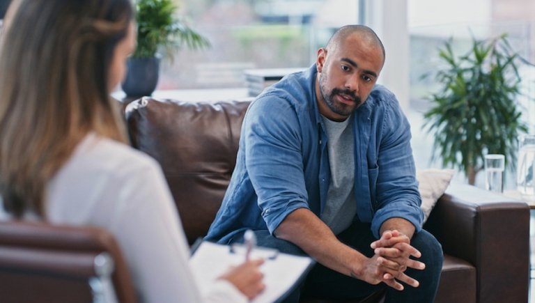 Doctor speaking to adult with autism. 