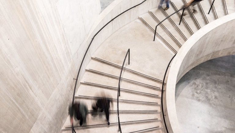 People walk down a staircase.