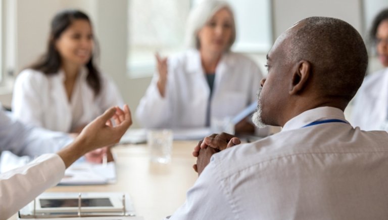 Group of health care professionals at a table.
