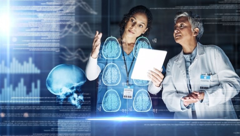 Two female doctors analyze brain scans
