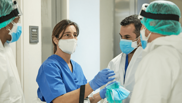 Health care workers talking with masks.