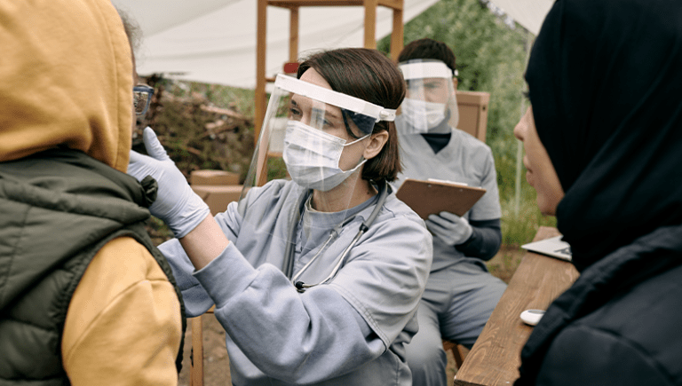 doctor with mask, preforming a covid-19 test on a women.