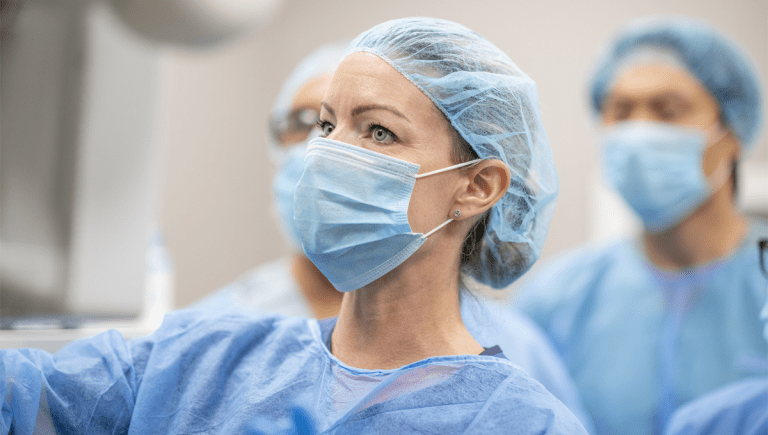 female surgeon with mask in the operating room.