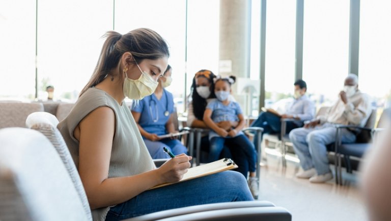 A patient fills out medical forms. 