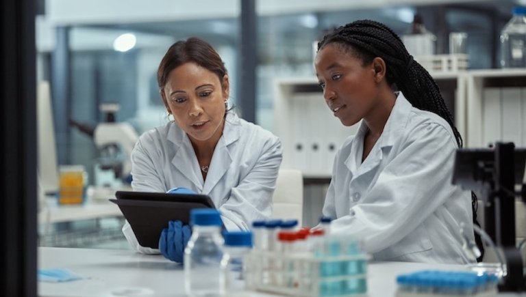 Two female doctors working in the lab looking at computer. 