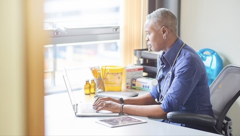 A woman typing on her laptop.