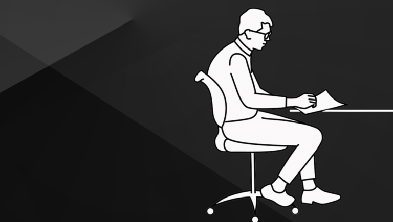 A man sitting alone at a desk.