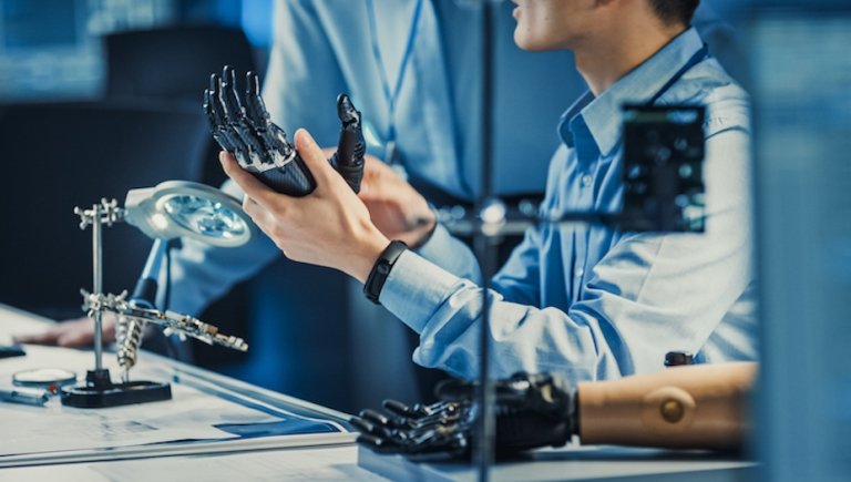 Physicians work robotic hand technology. 