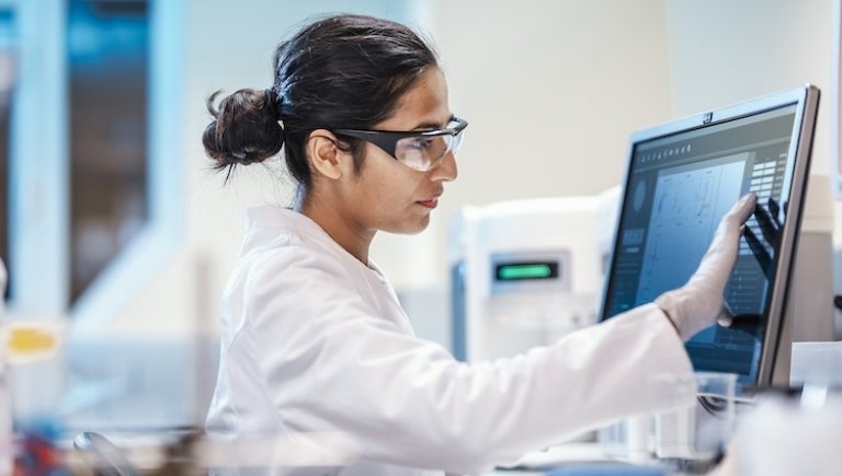 A doctor examining data on a computer.