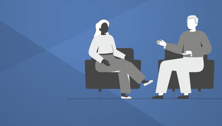 Two people sitting in chairs engaged in a conversation.