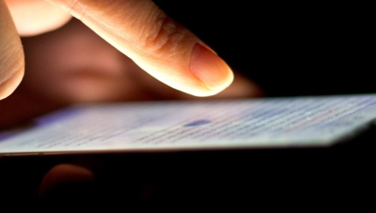 A person typing on a phone. 