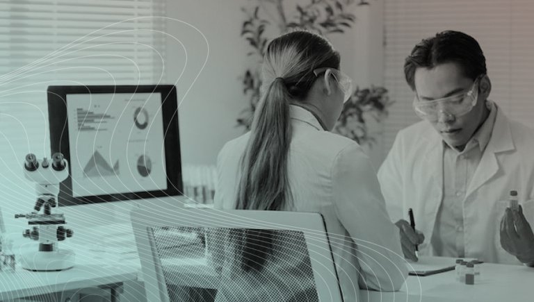 Two health care providers looking at data.