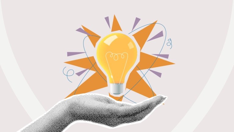 A hand holding an illustration of a lightbulb.