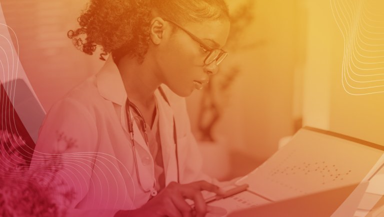 A health care provider looking at a screen with a red to yellow overlay over the image.