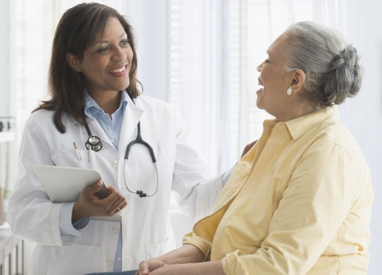 Doctor talking to patient in office