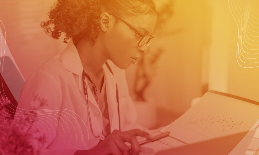 A health care provider looking at a screen with a red to yellow overlay over the image.