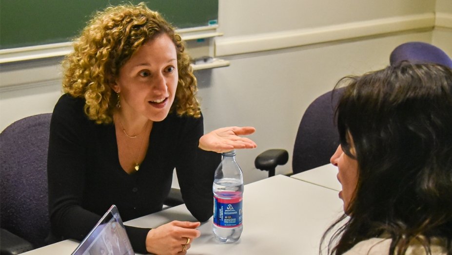 Two woman engaged in a conversation.