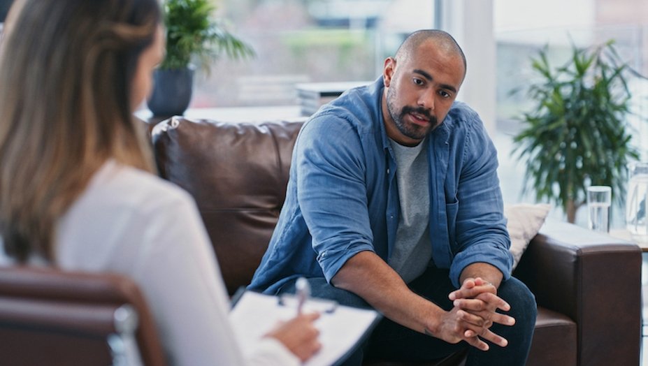 Doctor speaking to adult with autism.