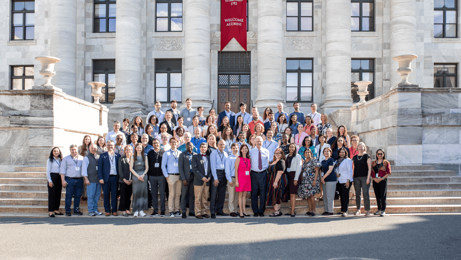 A class of students gathers in front of the Gordon Hall on the HMS campus.