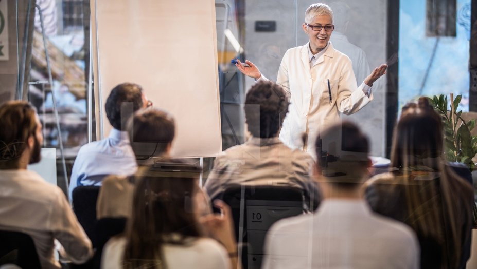 women presenting in a conference room.