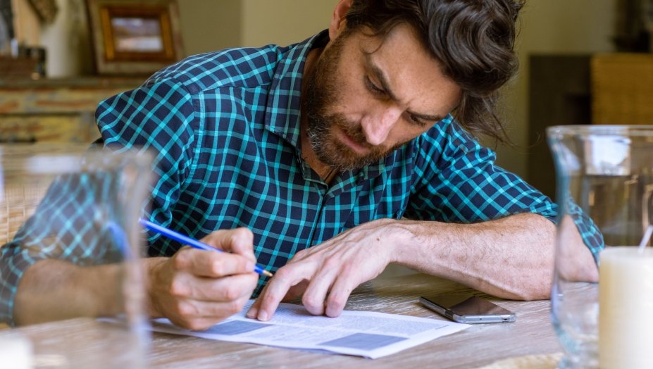 A person writing on a piece of paper.