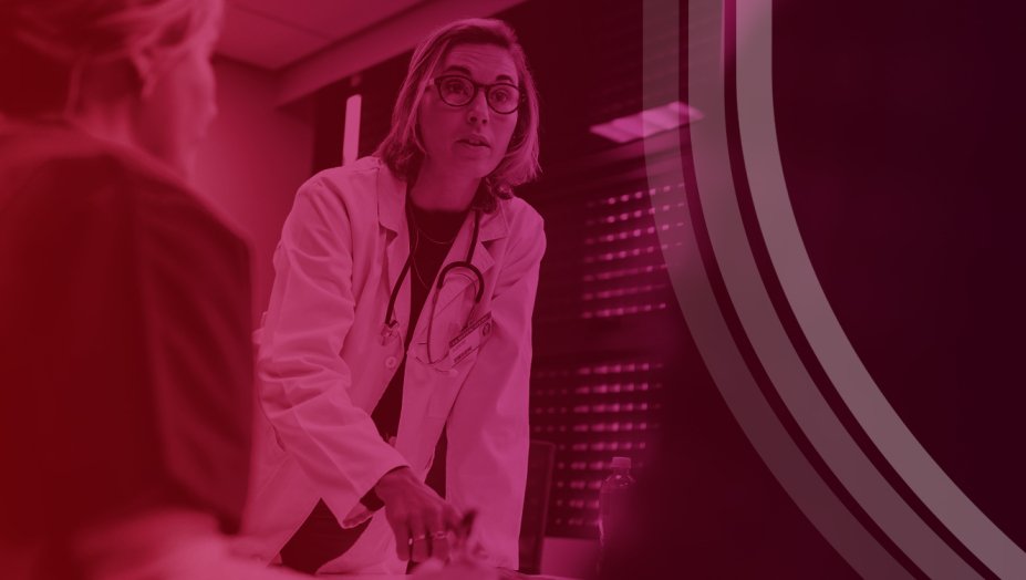 Medical Professional Leaning Over Conference Table