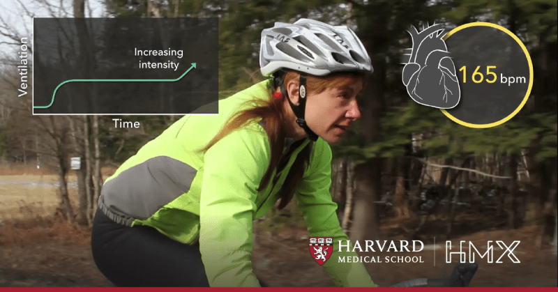 A biker going down a hill with statistics of their heart rate on their left and right.
