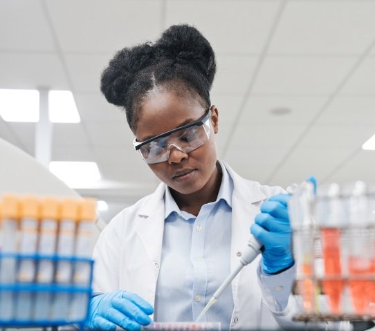 Scientist uses a pipette.